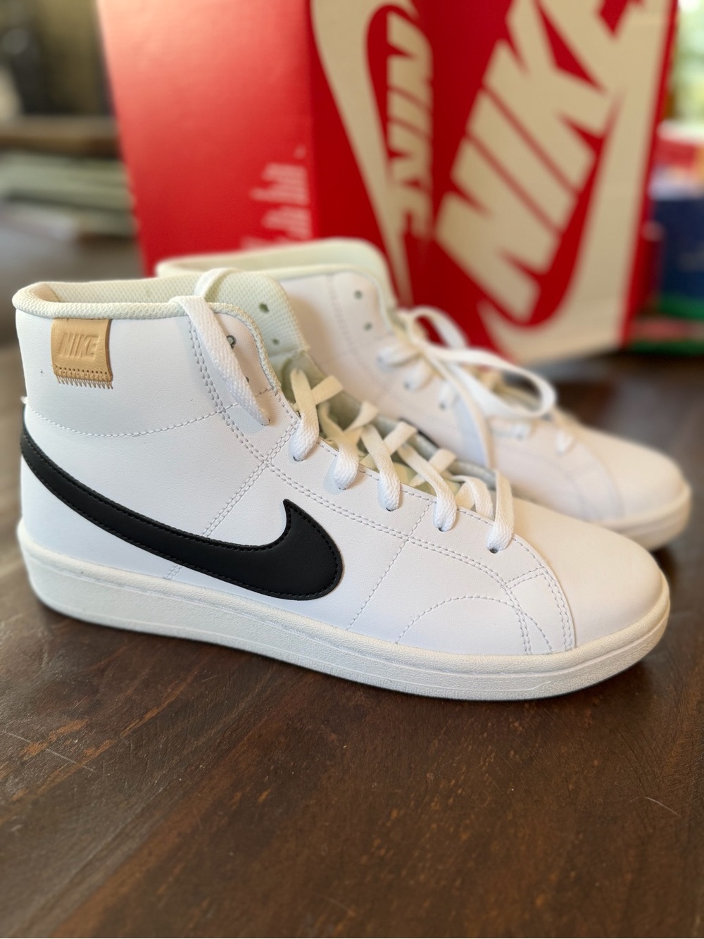 Nike White High-Top Sneakers with Black Swoosh and Gold Tab